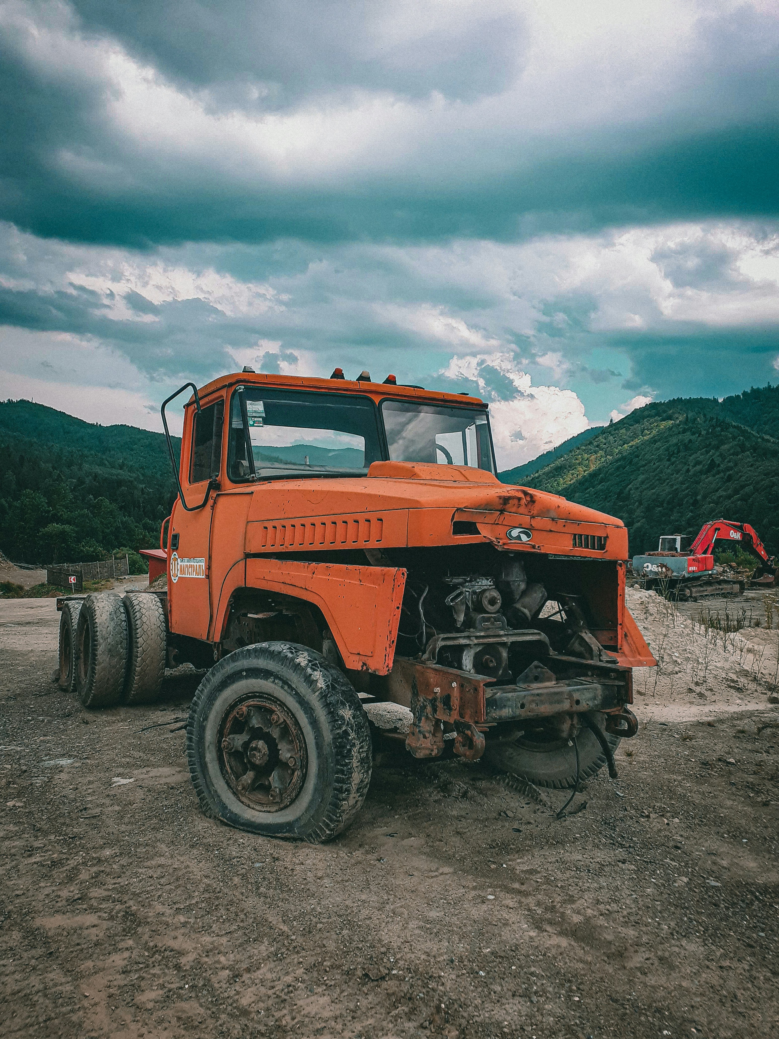 red and black tractor on brown sand during daytime