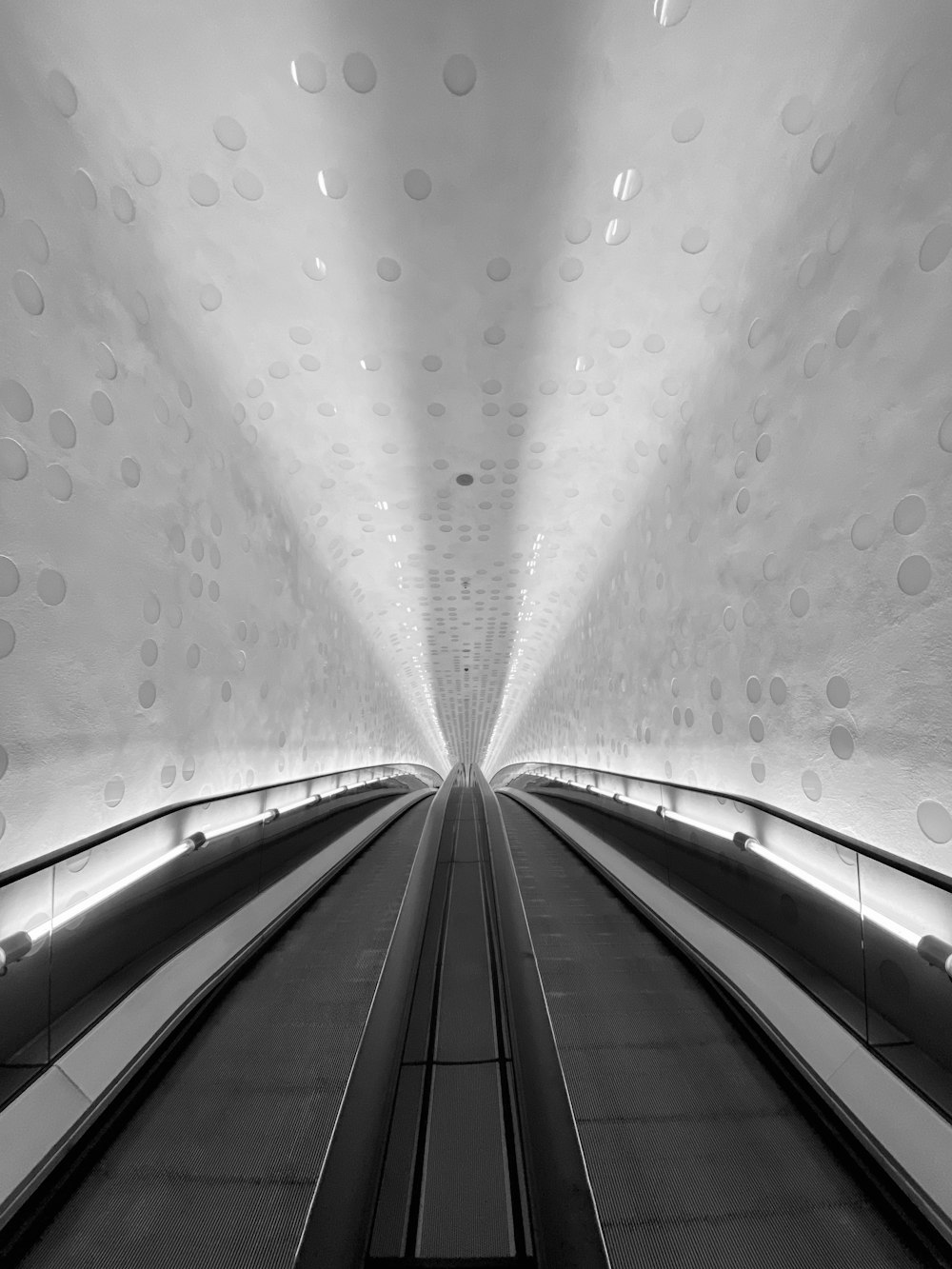 grayscale photo of tunnel with water droplets