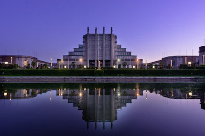 A serene architectural exterior at dusk featuring delicate shadows and clean lines.