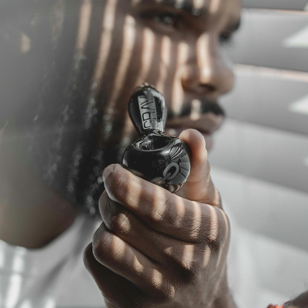 person holding black round ornament