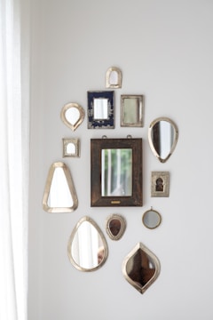 Elegant decorative mirrors installed in a modern living room reflecting natural light.