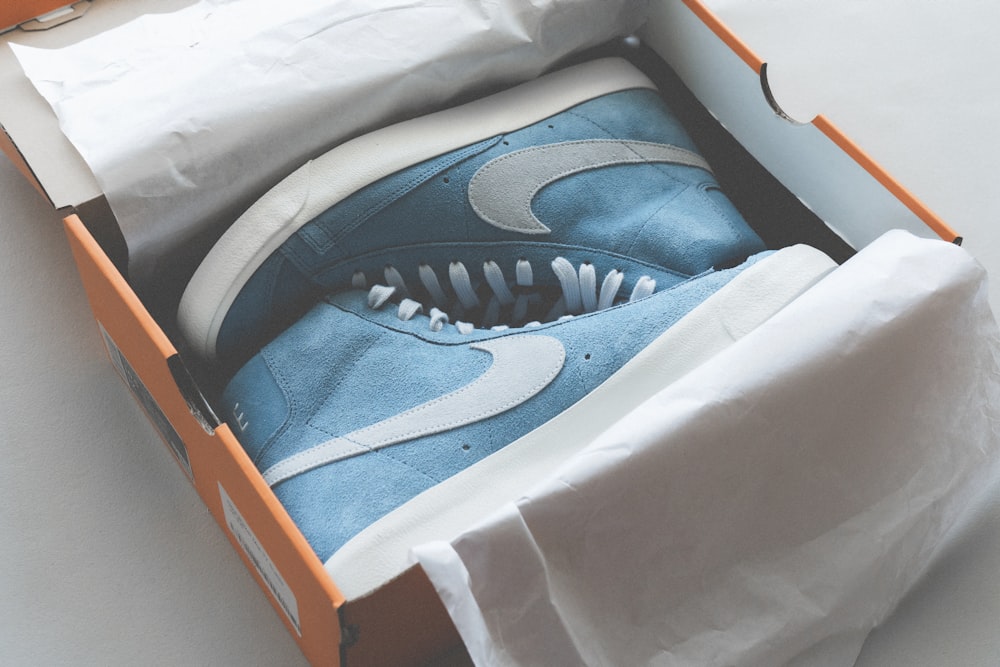 blue and white nike athletic shoes in box