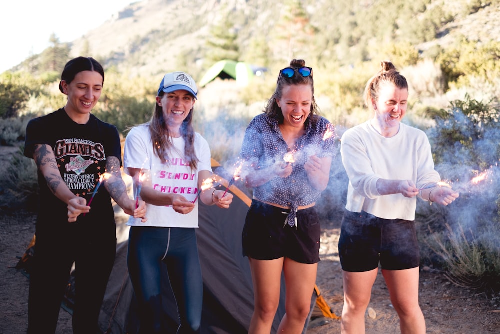 group of people holding a white plastic cups