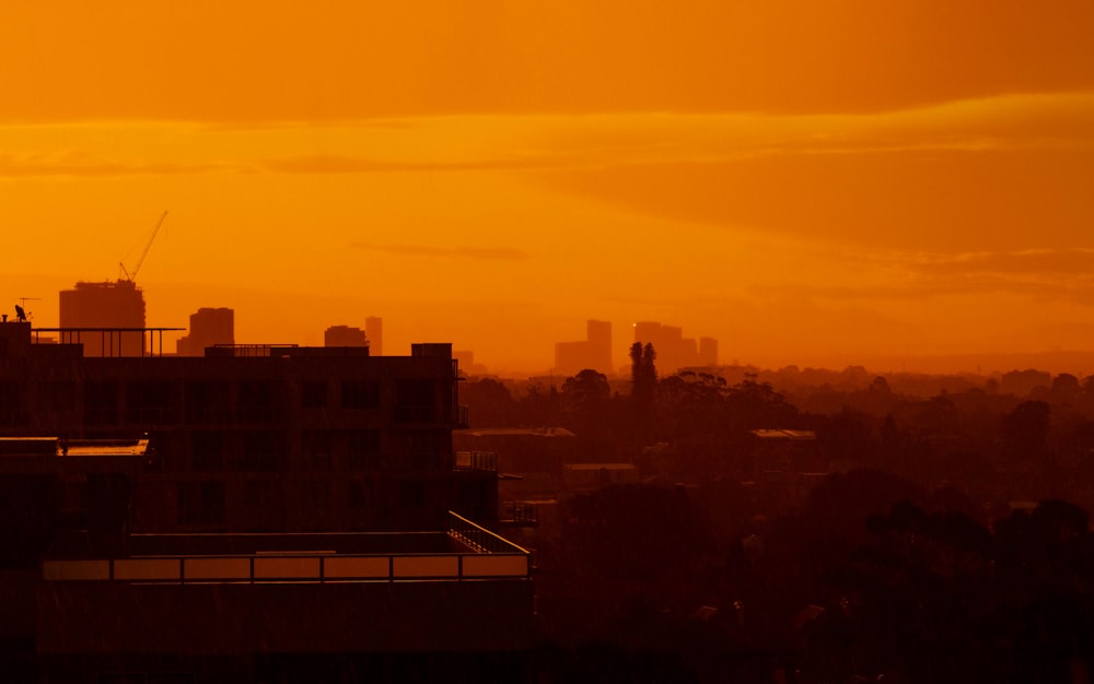 silhouette of city buildings during sunset