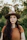woman in brown hat and orange knit sweater