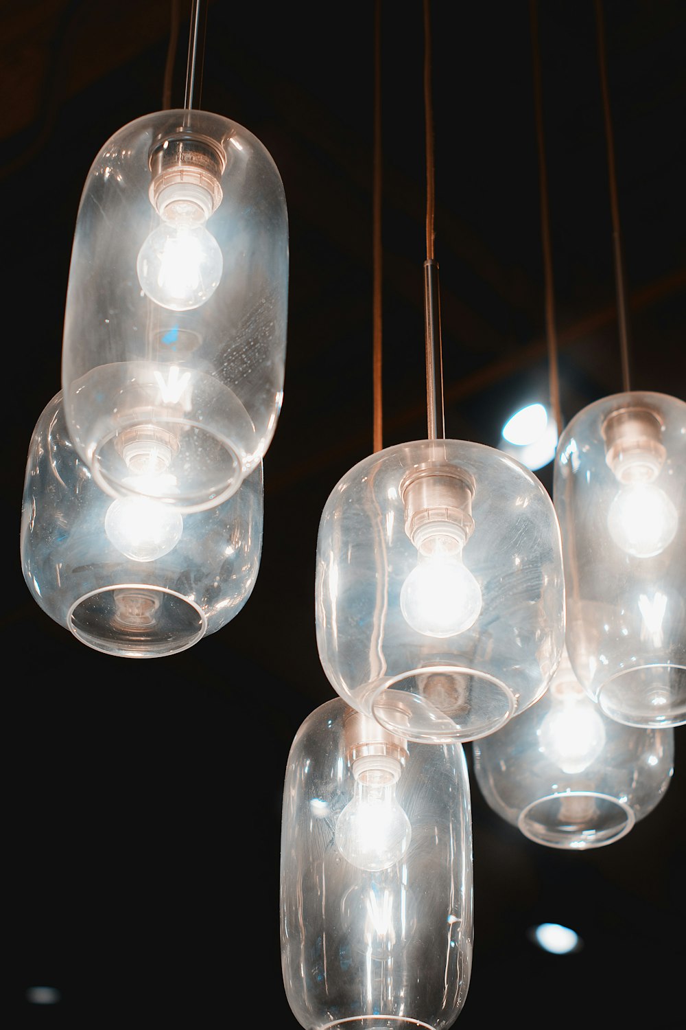 clear glass pendant lamp turned on in dark room