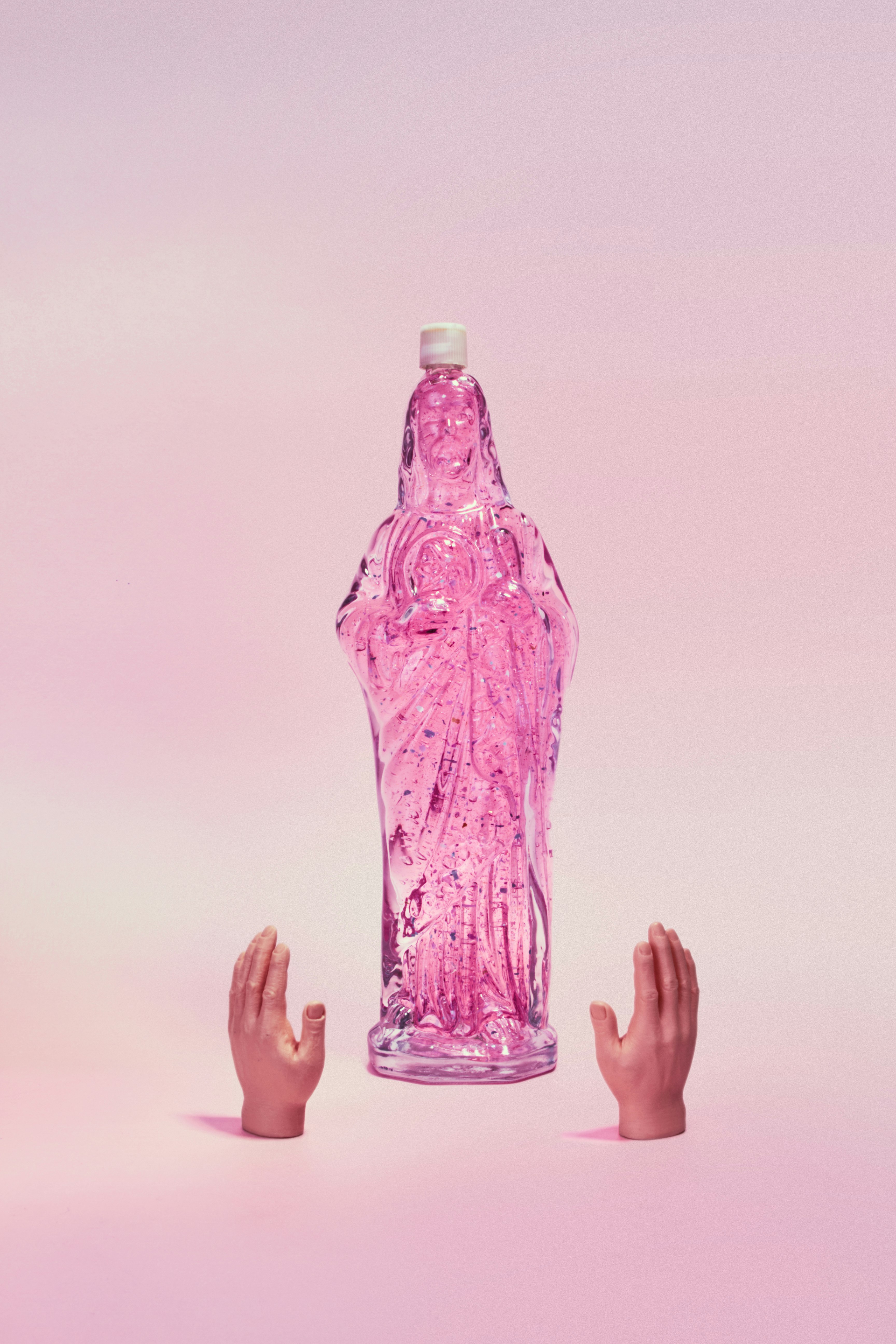 person holding purple plastic bottle