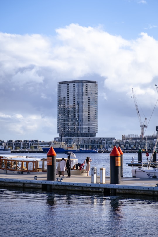 people on boat on dock near high rise buildings during daytime in Docklands VIC Australia