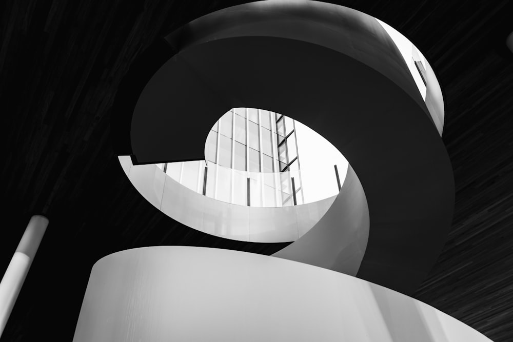 white spiral staircase in grayscale photography