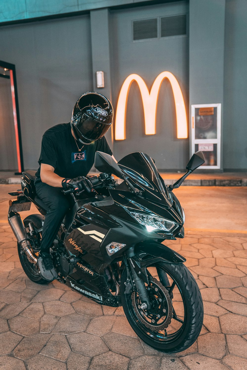 man in black helmet riding black sports bike