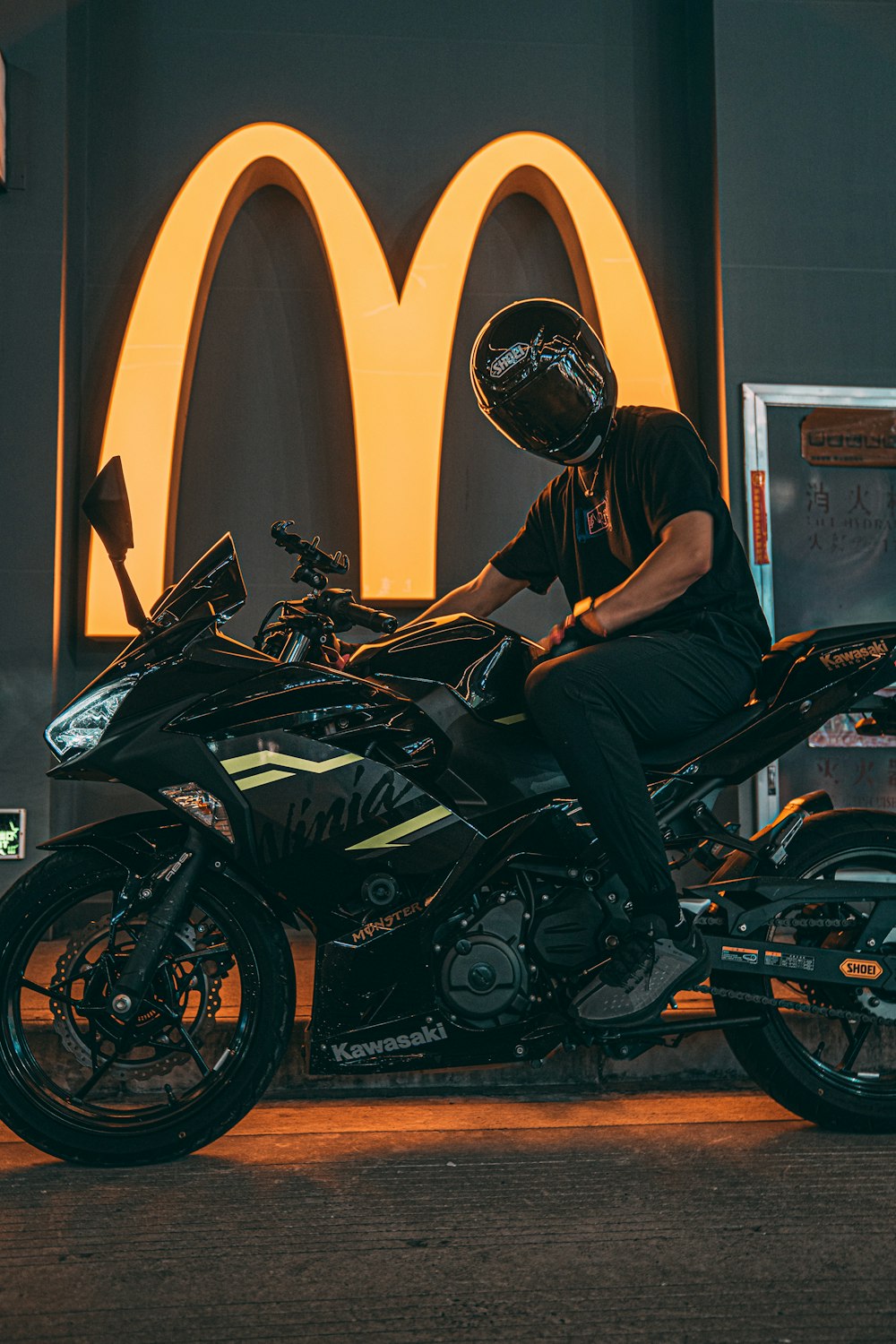 man in black helmet riding black and yellow sports bike