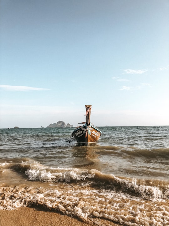 brown and black boat on sea under blue sky during daytime in Ao Nang Thailand