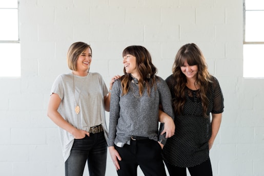 woman in gray crew neck t-shirt standing beside woman in black and gray long sleeve