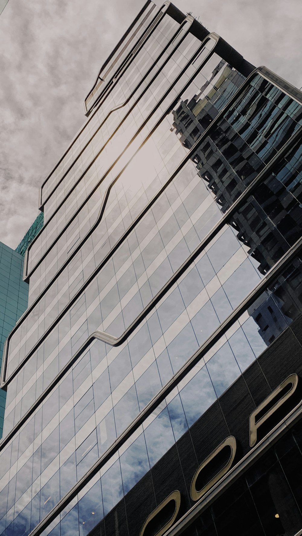 white and black concrete building under white clouds during daytime