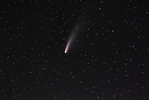 Close-up image of the bright comet 3I/Atlas against a starry background