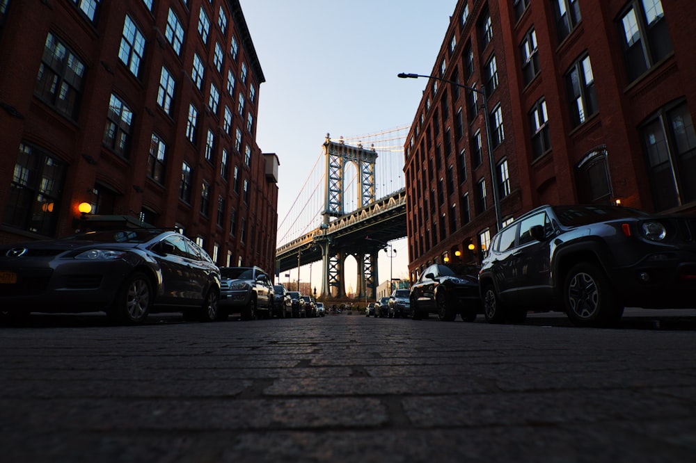 cars parked on side of the road near buildings during daytime