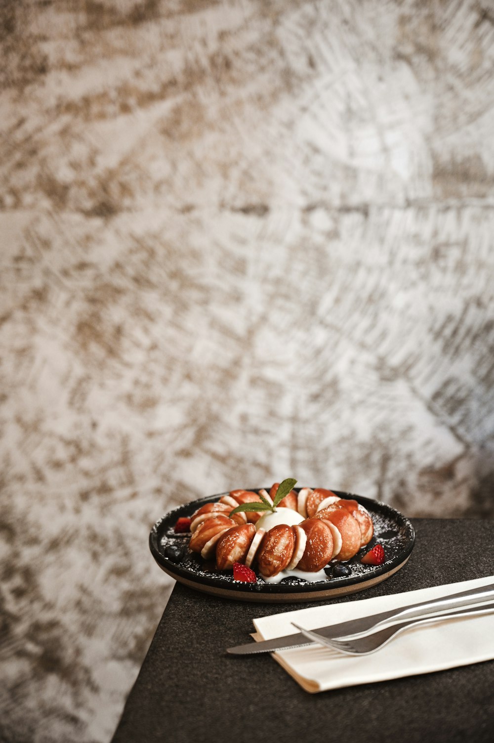 sliced tomato and green vegetable on black ceramic plate