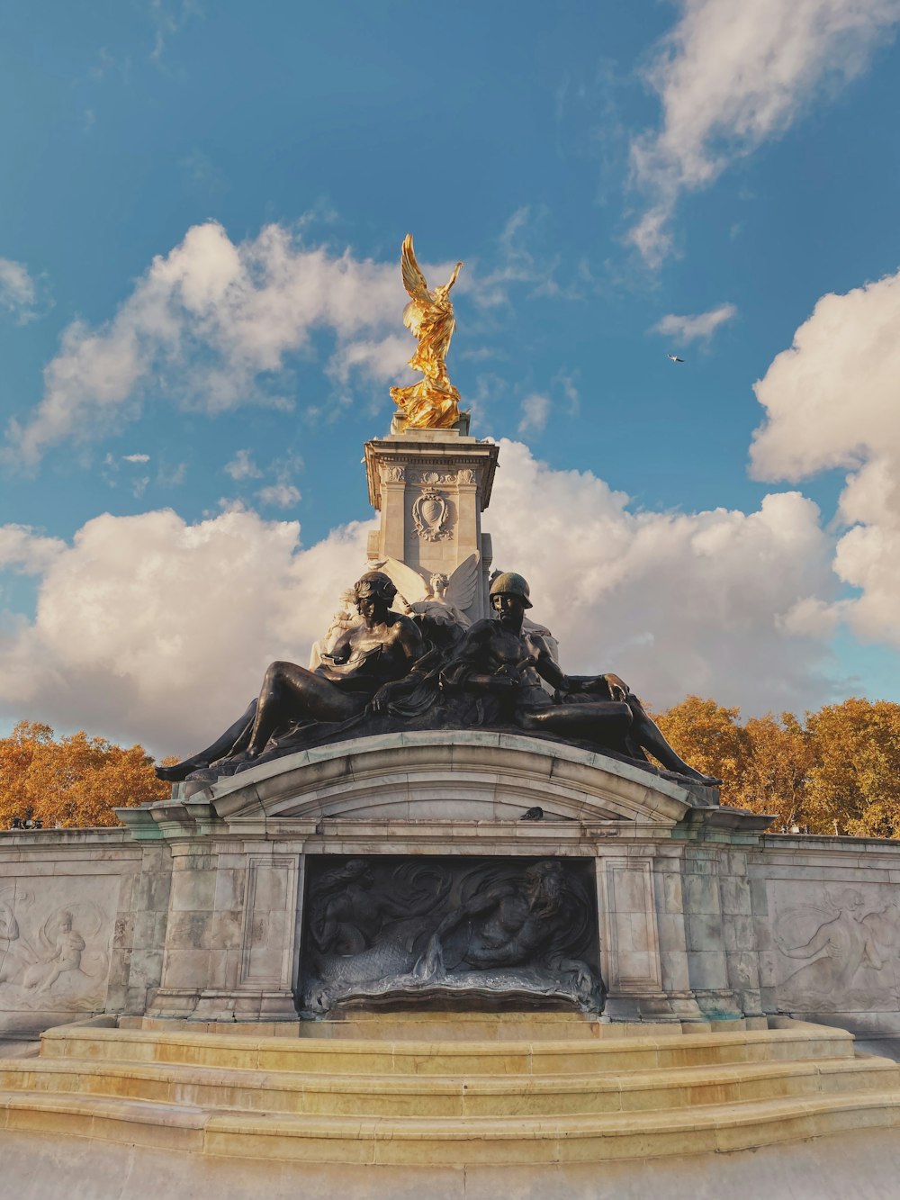 gold statue under blue sky