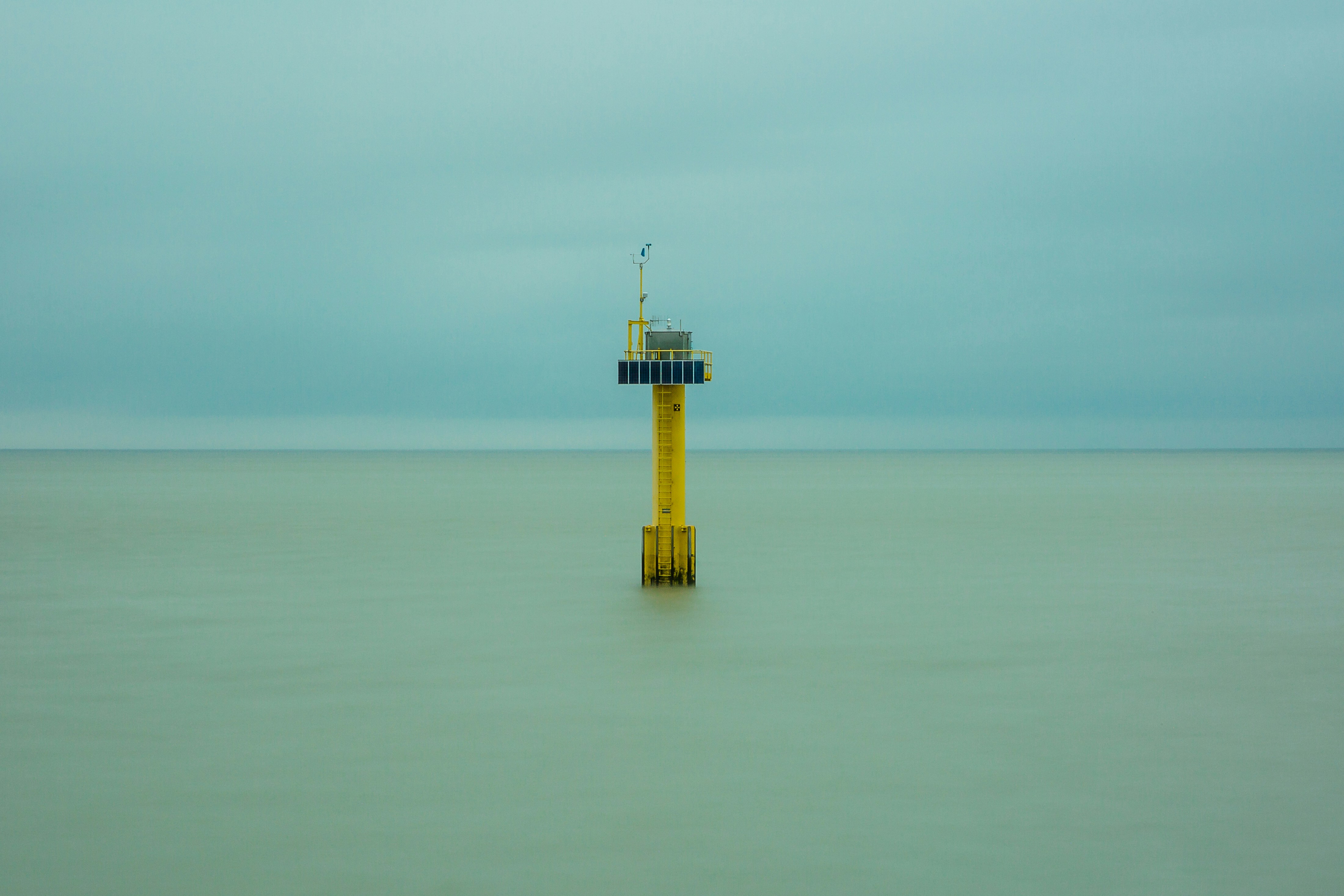 Yellow and white tower on the middle of the sea photo – Free Building ...