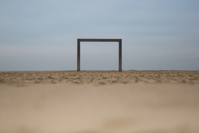 brown wooden stand on brown sand during daytime