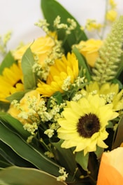 Bright sunflowers in a cheerful bouquet with greenery.
