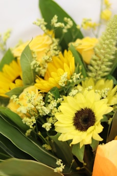 Bright sunflowers in a cheerful bouquet with greenery.