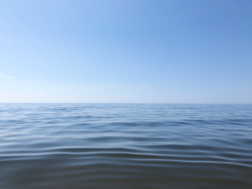 body of water under blue sky during daytime