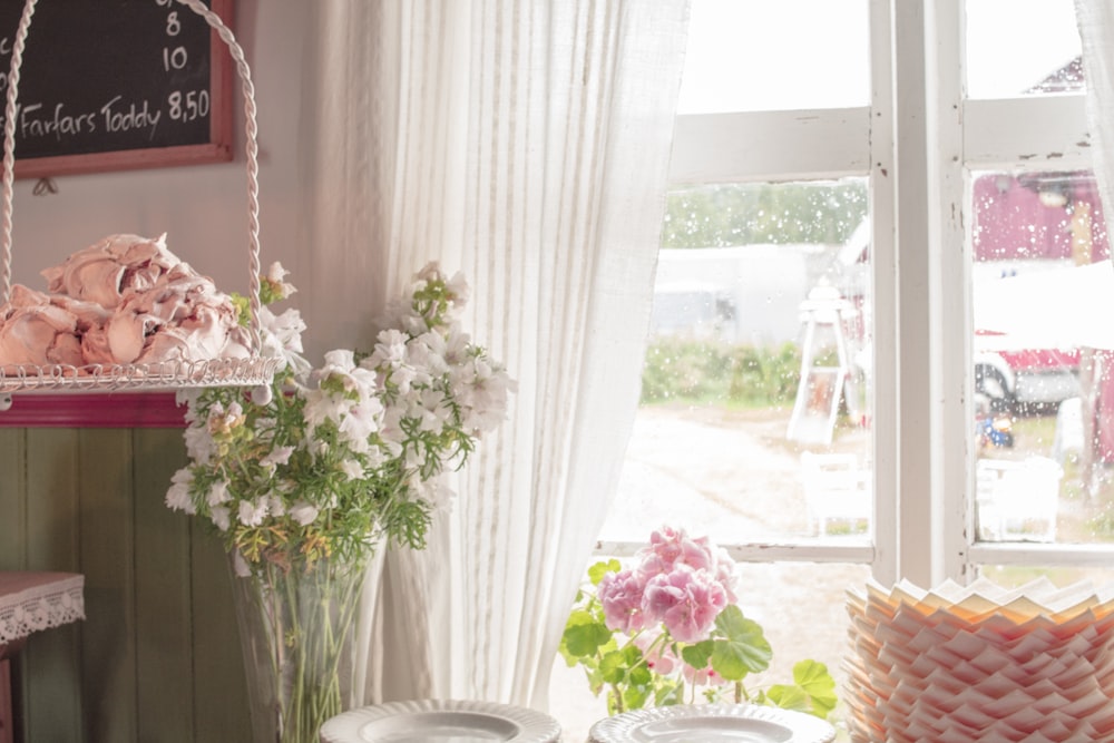 white and pink flowers on white ceramic vase