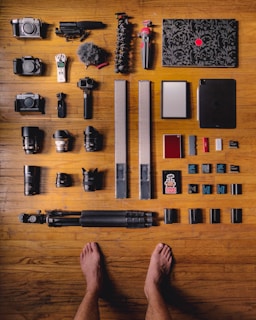 black and silver dslr camera on brown wooden table
