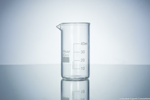 clear glass measuring cup on white surface