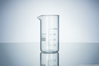 clear glass measuring cup on white surface