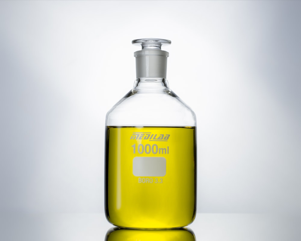 yellow glass bottle with white background