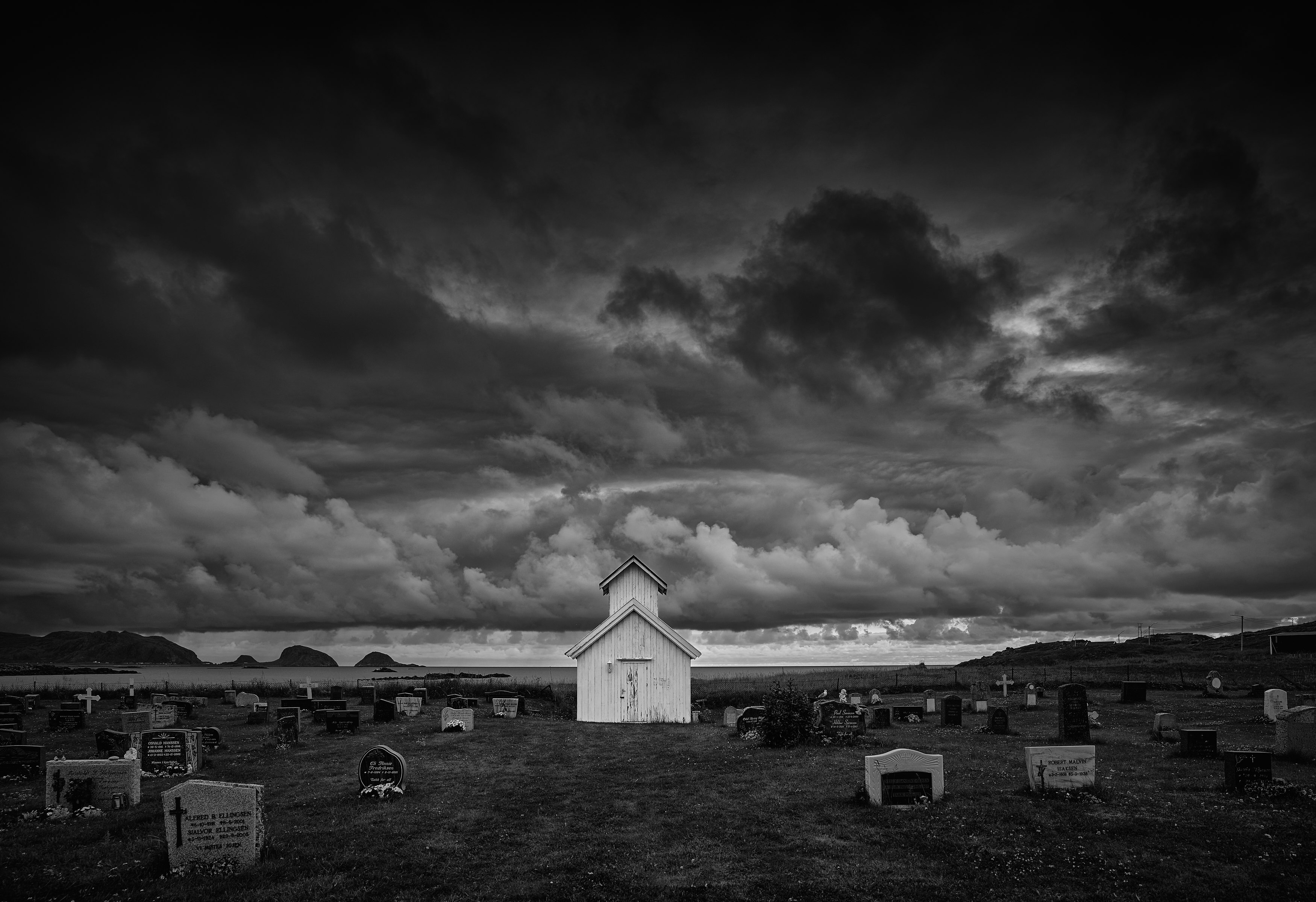 grayscale photo of houses under cloudy sky