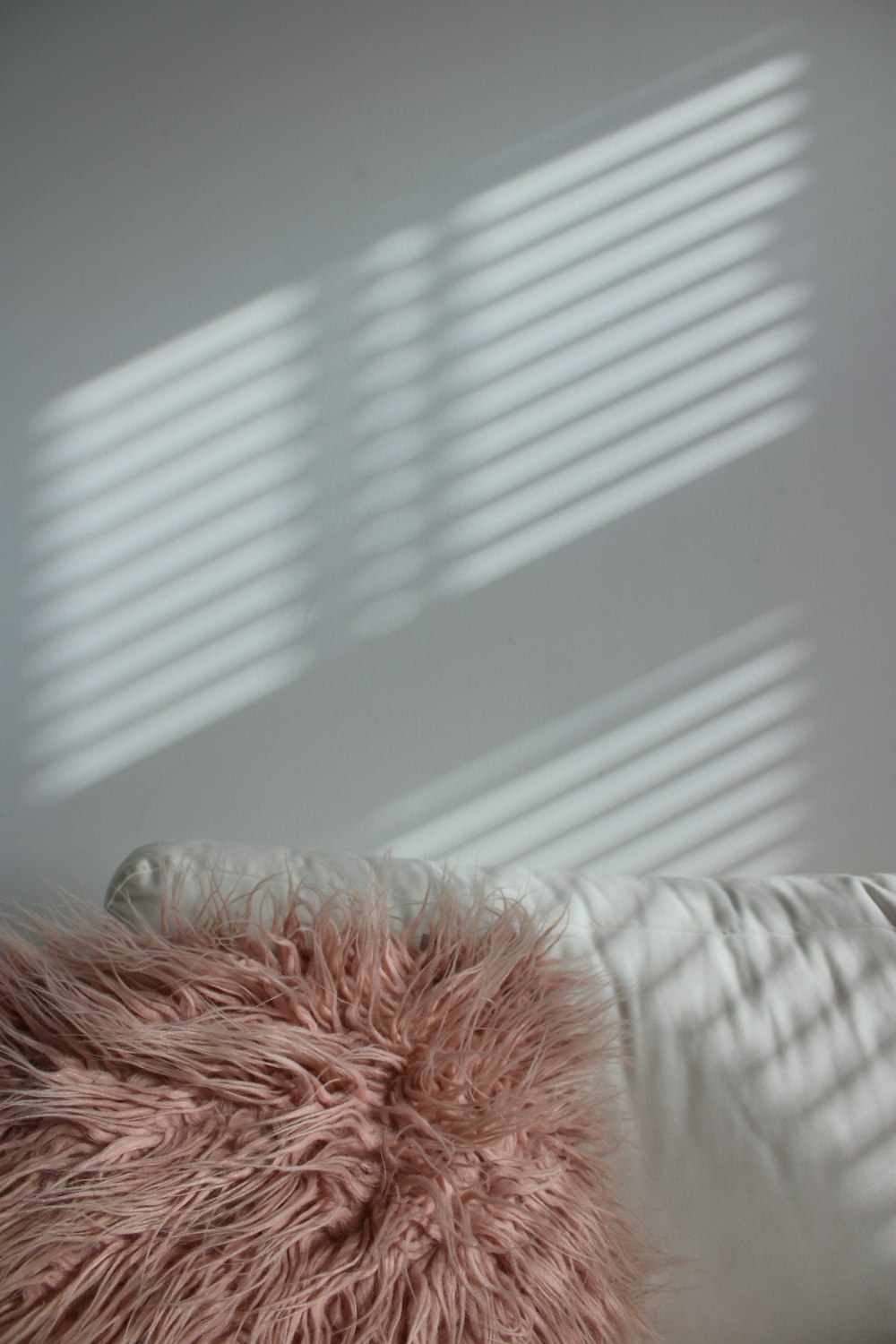 white textile near white window blinds