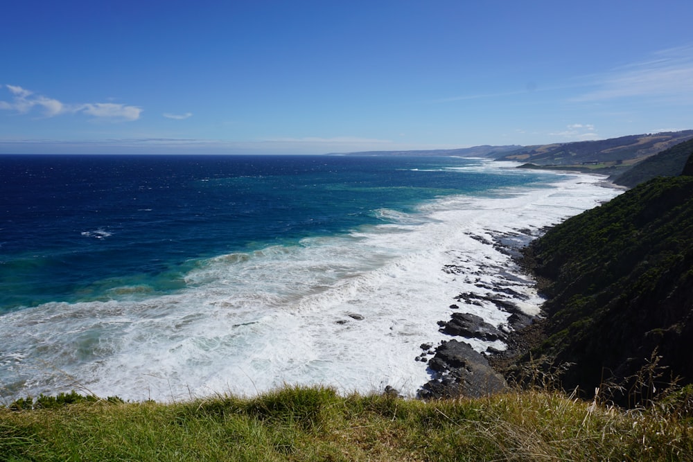 a view of the ocean from the top of a hill