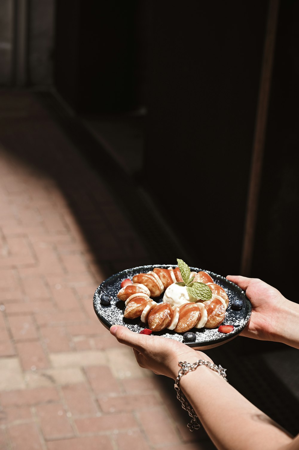 person holding plate with sliced of fruits