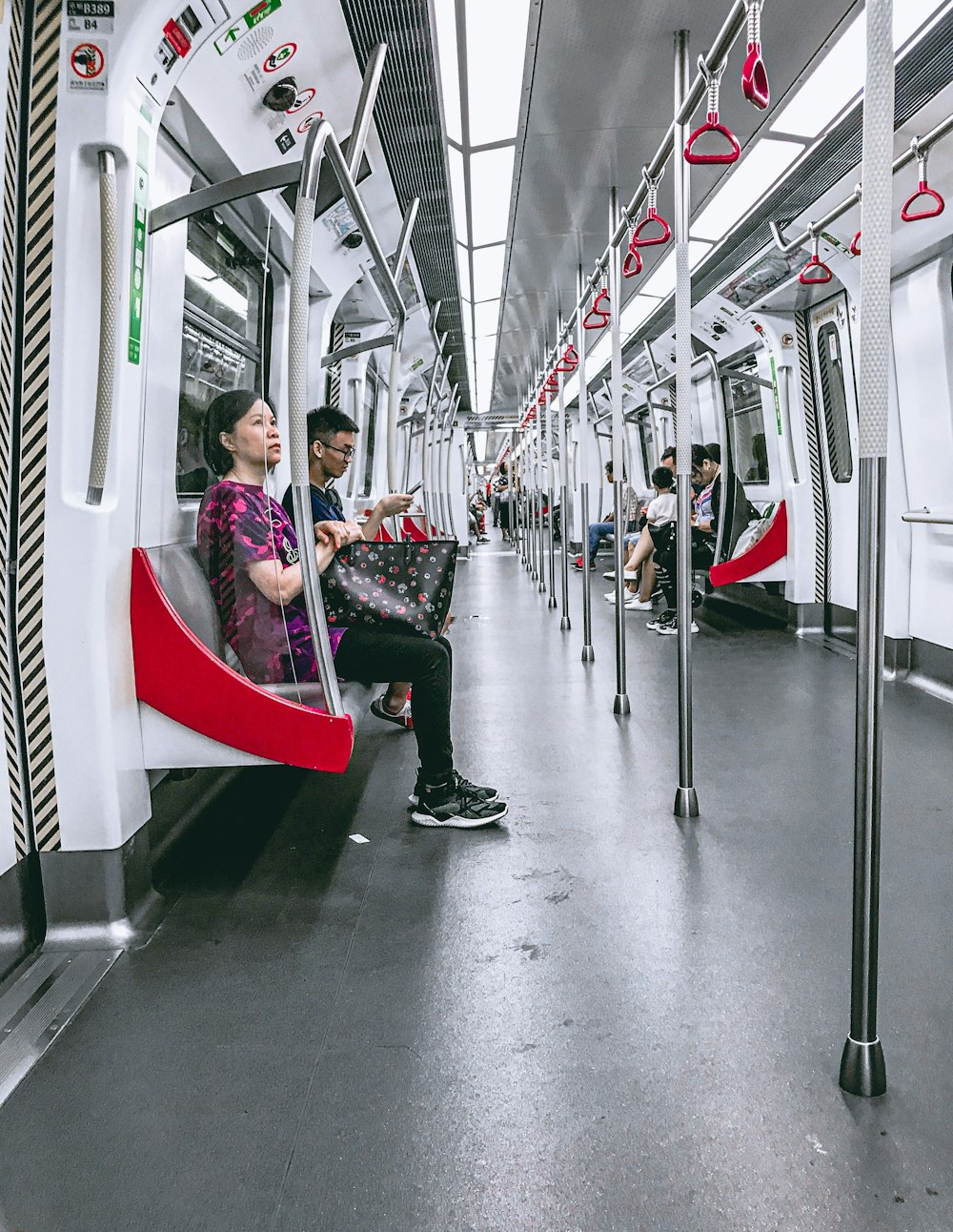 people sitting on red and white train