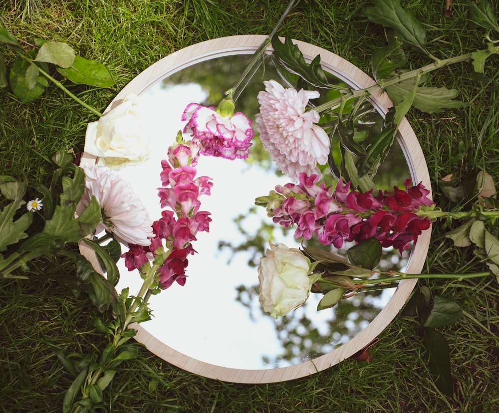 pink and white flowers on white round plate