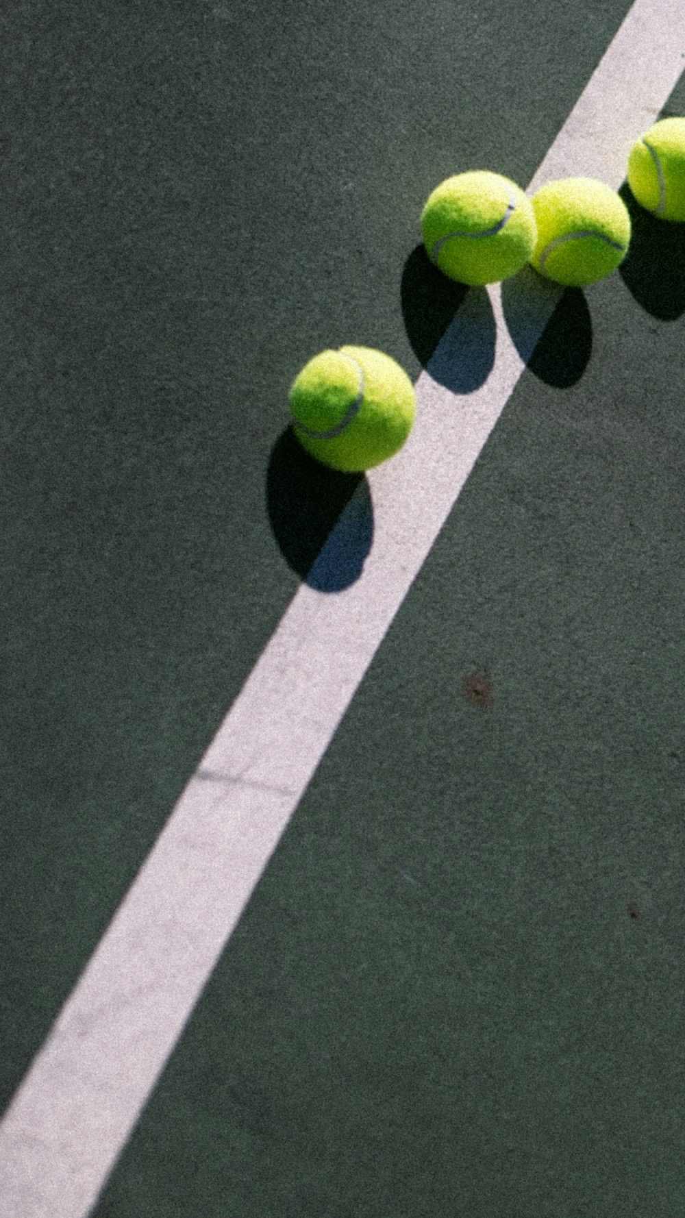 a tennis court with four tennis balls on it