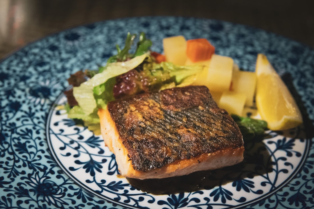 cooked food on blue and white floral ceramic plate