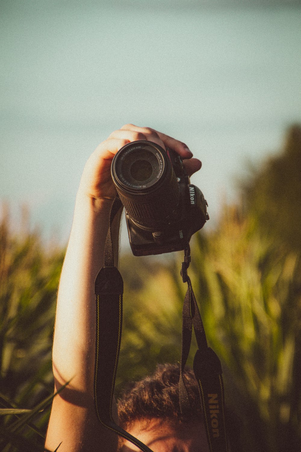 person holding black dslr camera