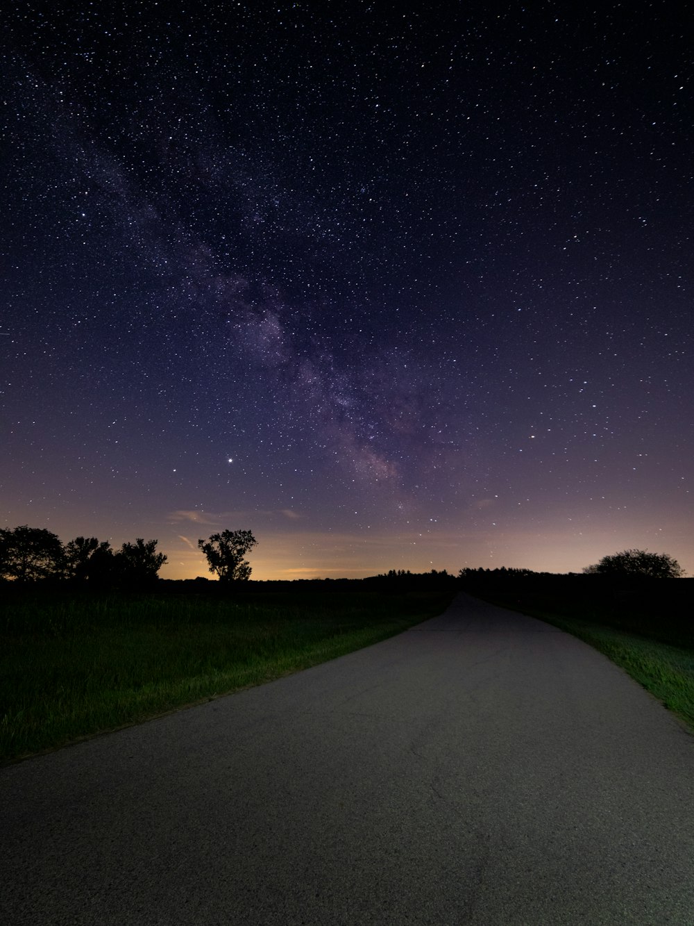 green grass field under starry night