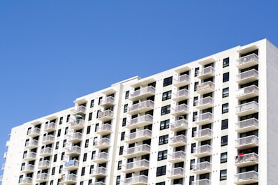 Sunny residential apartment building with balconies and street view