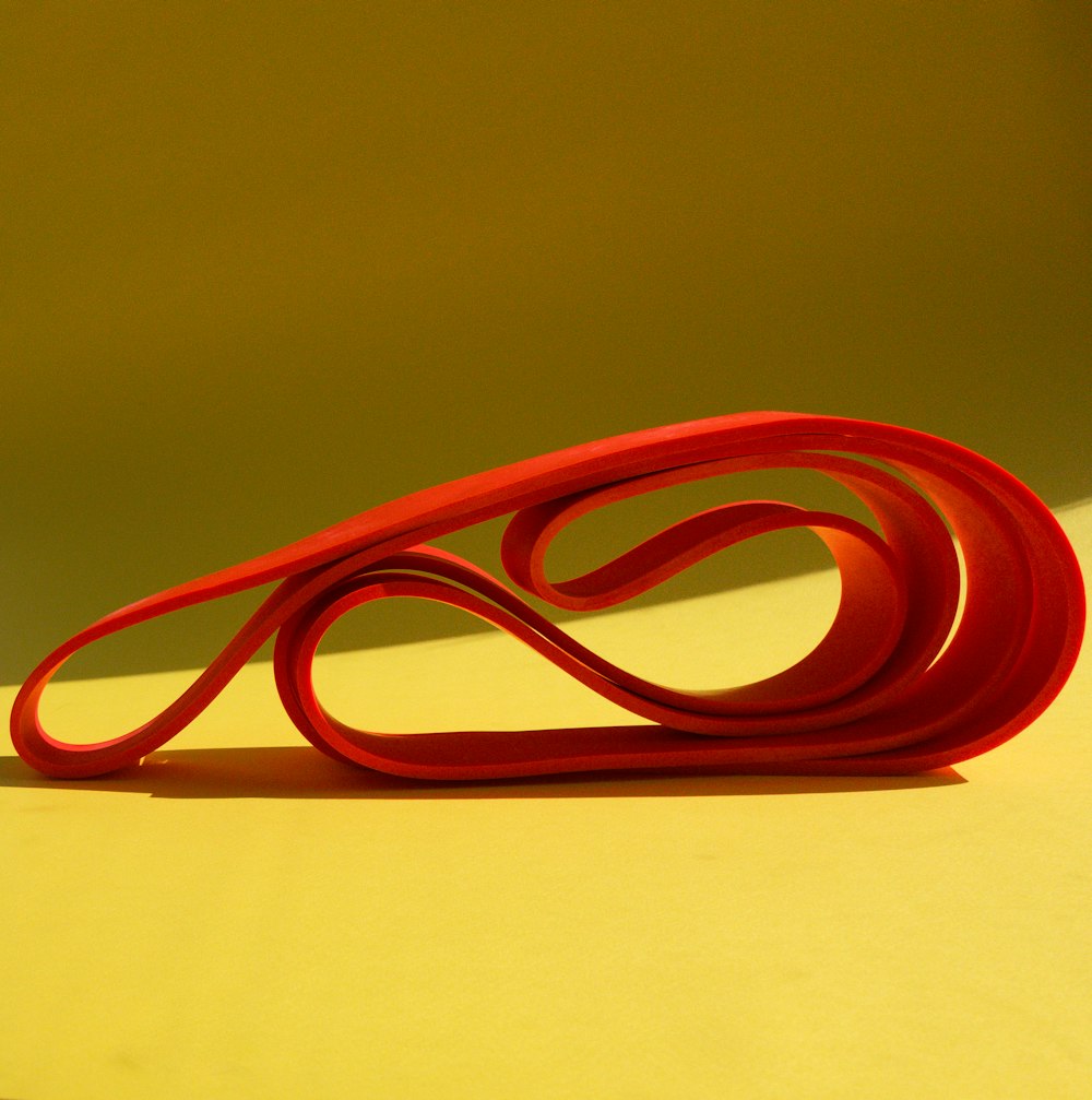 red rubber band on white table