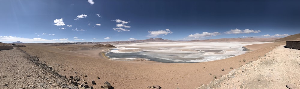 brown sand near body of water during daytime