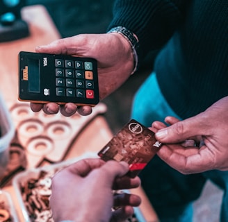 person holding black and silver calculator