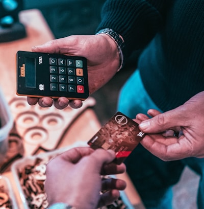 person holding black and silver calculator