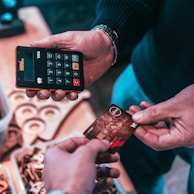 person holding black and silver calculator