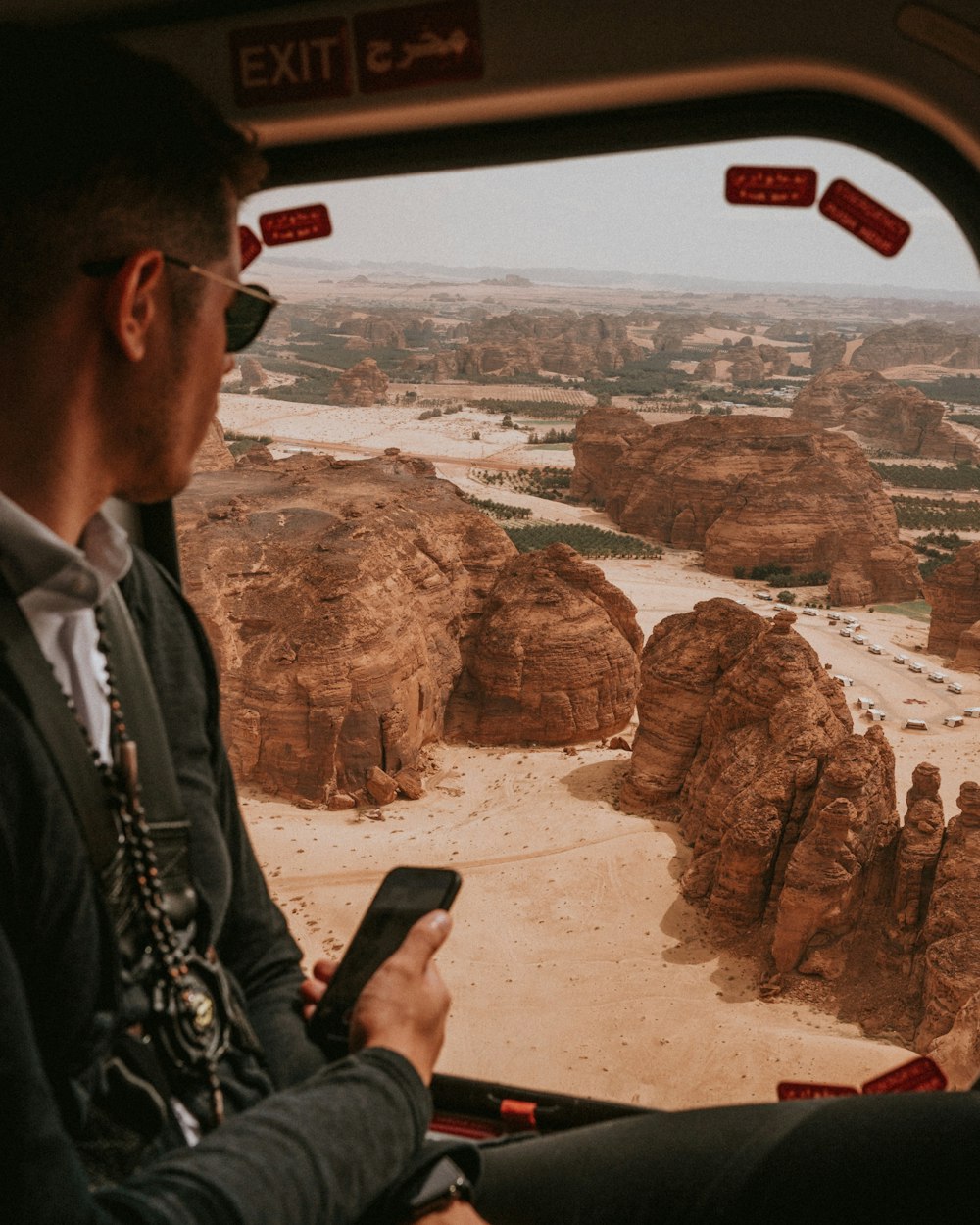 man in black jacket holding smartphone