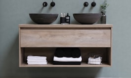 white and black ceramic bowl on brown wooden shelf